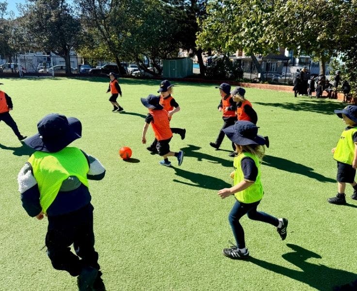 Photo of students playing on our soccer sports field.