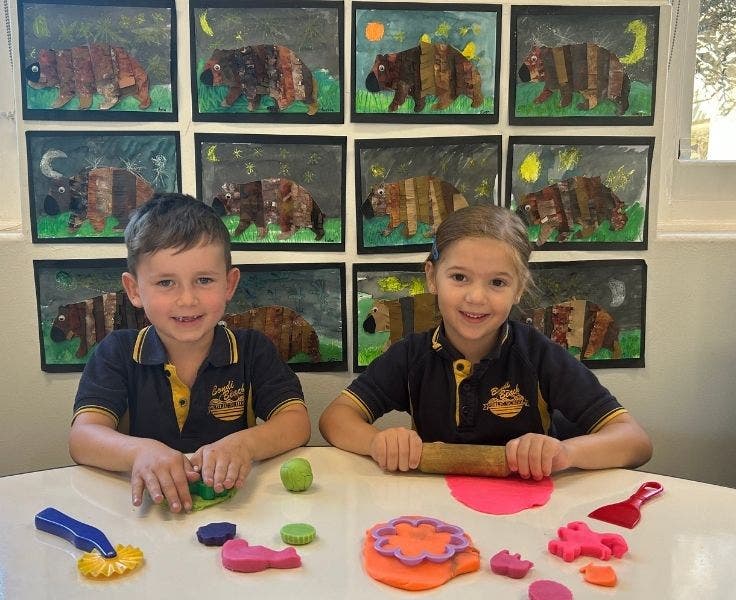 Photo of two students getting hands on with play dough.