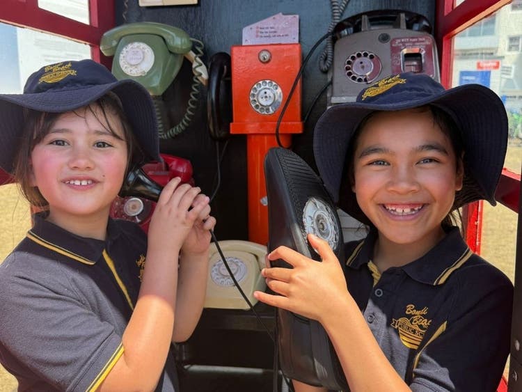 Photo of two students inside the Phone Zone art installation at Sculptures by the Sea.