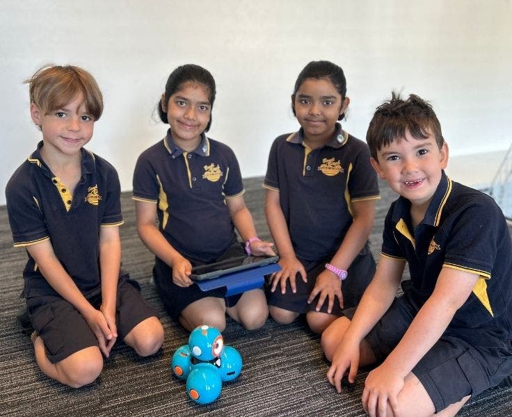 Four students participating in code club.