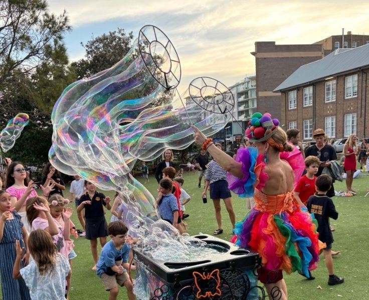 Photo of students enjoy bubble magic during our welcome BBQ.